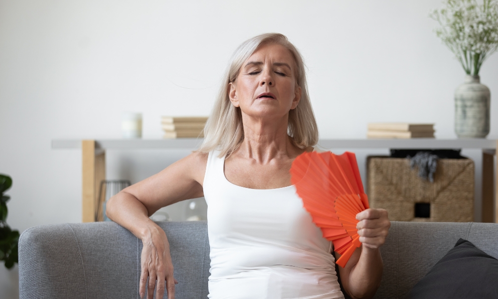 Woman in her late 30s experiencing early menopause symptoms including hot flashes and irregular menstrual cycles
